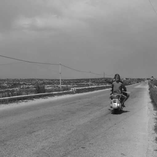 Fotograma de una carretera de Lampedusa con la protagonista viajando en una motocicleta